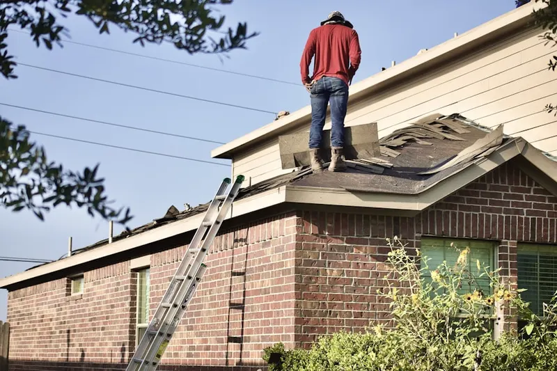 Professional roofer working on a residential roof in Prairie Lake
